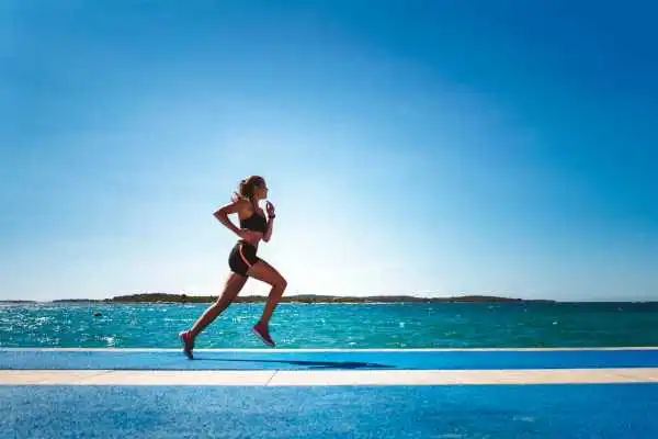 Woman running showing strong leg muscle Burton upon Trent